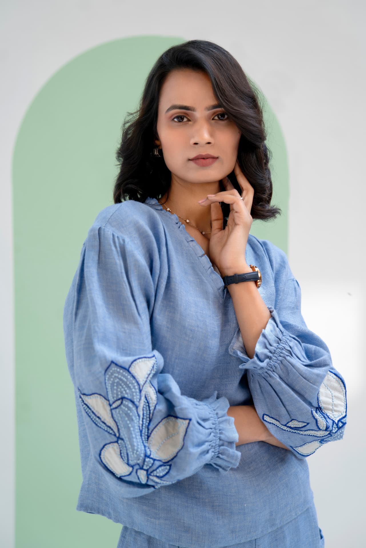 Portrait of a model in a chambray blue embroidered top